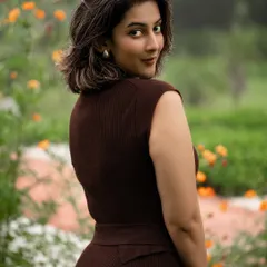 An outdoor portrait of a model in a chic brown dress, showcasing our ability to use natural light and environments to create compelling fashion images that feel both elegant and authentic.