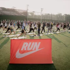 A wide shot of a Nike Run event, where I led the post-run yoga and mobility session. The sea of mats on the green turf is an inspiring sight.