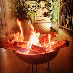 For those chilly winter evenings, I can set up a safe and stylish bonfire. This portable fire pit brings warmth and a mesmerizing glow to the balcony, creating a perfect gathering spot.