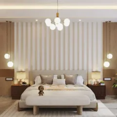 This bedroom is a study in symmetry and texture. The fluted paneling behind the bed, flanked by hanging globe lights, creates a visually interesting and balanced focal point.