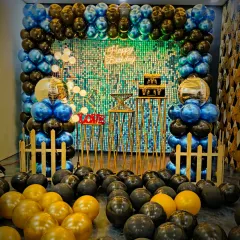 Another angle of the popular blue, black, and gold theme, showing the floor covered in balloons. This creates an immersive experience for guests from the moment they walk in and provides a great photo opportunity.