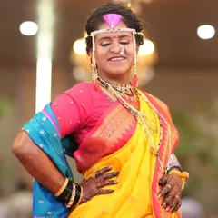 Confidence and joy. This bride is striking a pose, and her dark mehendi stain is the perfect accessory to her vibrant wedding attire.