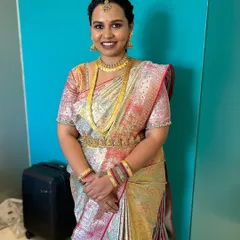 A full-length portrait showing how the makeup, hairstyle, and saree come together for a complete, elegant look. The dewy skin finish gives her a healthy, natural glow.