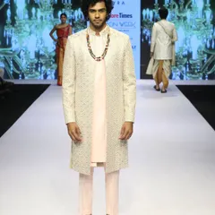 This shot captures the modern Indo-Western look from the back and front. The clean tailoring and thoughtful layering demonstrate a sophisticated approach to men's occasion wear.