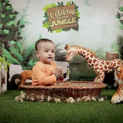 A happy, clapping baby enjoys his time in the studio jungle. We encourage play and interaction to capture the most natural and joyful expressions.