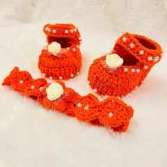 This vibrant orange set includes Mary Jane-style booties and a matching headband, both decorated with pearls and a small white rose.