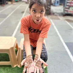 This young client is showing off her beautiful floral mehandi with a big, happy expression. I love creating designs that kids enjoy.
