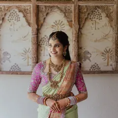 For this bride's wedding, we chose a soft glam look with a hint of color on the eyes and a neutral lip. This balanced her vibrant pink and green saree and heavy temple jewellery perfectly.
