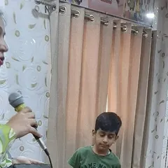 I guide each student personally during our public speaking exercises. Here, I am helping a young boy structure his thoughts before he addresses his peers, building his confidence one step at a time.