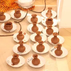 A closer look at the miniature clay pots crafted by students. This pottery activity teaches them about symmetry, form, and the properties of clay.