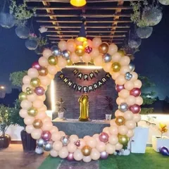 A first anniversary celebration on a beautiful terrace. I used a ring of peach, gold, and silver balloons to frame the "Happy Anniversary" banner and a large foil '1' balloon, making the most of the lovely outdoor space.