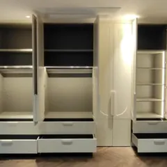 The interior of this wardrobe is just as impressive as its exterior. We incorporated sensor-activated LED strip lighting, multiple drawers for small items, and a mix of hanging spaces and adjustable shelves for complete organization.
