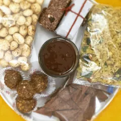 My travel-friendly snack platter, featuring spiced makhana, millet flakes mixture, gluten-free nachos, nutritional bars, and hazelnut nutella. Healthy eating, wherever you are.