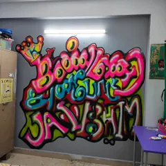 Another angle of the finished Tamil graffiti mural in my daughter's room. The bright, popping colors and dynamic lettering create a focal point that is both art and a declaration of identity, perfect for a teen's personal space.