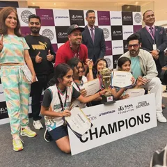 A huge win for Crossovers Academy at the Navi Mumbai Seawoods Nexus mall tournament. Our U-12 girls team stands with their coaches and supporters, holding the 'Champions' banner and trophy.