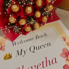A classic love language. This beautiful bouquet combines decadent Ferrero Rocher chocolates with red floral accents and a personalized "Welcome Back My Queen" card, making for a sweet and romantic surprise.