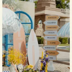 Transporting guests to the Amalfi Coast without leaving Jaipur. This photo from a Positano-themed Mehendi shows how I use specific, sensory details like directional signs, surfboards, and striped umbrellas to build a completely immersive world. It’s about creating a vibe that is playful, sunny, and full of discovery.
