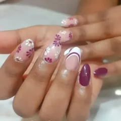 A creative set combining floral patterns, a solid color, and a modern French tip for a truly unique manicure.