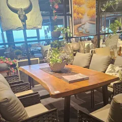 A view of our 16,000 sq. ft. showroom, the largest collection of outdoor furniture in East India. This dining set features a live-edge wooden table, perfect for a rustic-chic terrace.