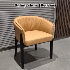 This is our 'Geneva' model dining chair in a warm tan leatherette. It features a comfortable, curved back and a sturdy black wooden frame, making it ideal for long dinners.