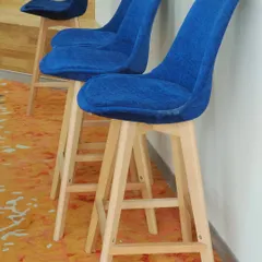 Our high counter chairs with natural beech wood legs and a comfortable blue fabric seat. This is a simple, sturdy design perfect for cafes or homes.
