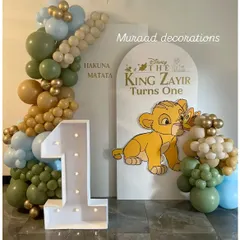 For this first birthday, we brought the world of The Lion King to life. The setup features a custom "Hakuna Matata" backdrop, a light-up marquee number '1', and a cute Simba cutout, creating a perfect photo spot for the little one.