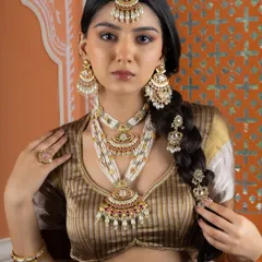 The full bridal ensemble, including a layered necklace, maang tikka, chandbali earrings, bangles, and hair accessories. We provide complete, coordinated sets for retailers catering to the bridal market.