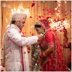 The Varmala ceremony, showered in rose petals. This iconic moment is captured to show the joy and significance of the couple's union.