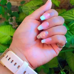 This is the amazing result from one of my students. They created this beautiful ombre nail set with a French tip effect and an accent nail featuring delicate encapsulated dry flowers and glitter.