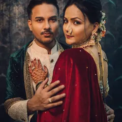 A powerful and intimate royal-themed couple portrait, showcasing a deep connection with moody, cinematic lighting and rich, traditional attire.