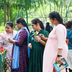 Adult learners observing plants during a Nature Walk, a part of our contact classes. We believe in slowing down and connecting with nature, just as we teach children to do.