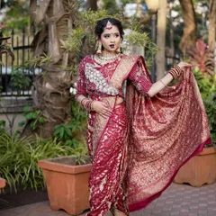 A full-length view of a bride in a stunning maroon `Navari` saree. I ensure the draping is perfect to create an elegant and powerful silhouette for the modern Maharashtrian bride.