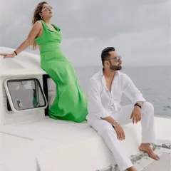 Komal and Akhil on a yacht in Phuket, a picture of glamour and luxury against the open sea.