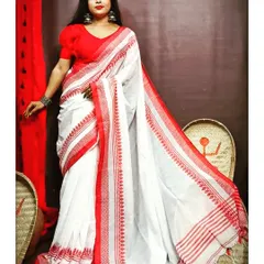 This is the iconic 'lal paar' saree, a must-have for Durga Puja. The classic white cotton saree with a simple red border is timeless. I rent it with a pre-stitched red puff-sleeve blouse to give you a complete, ready-to-wear traditional Bengali look.