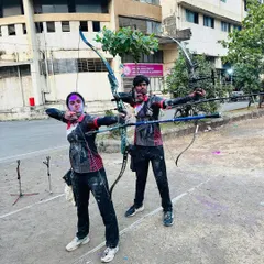 Archery and Holi celebrations. Two of our students take a fun shot together, covered in colors, showcasing the fun and festive side of our academy.