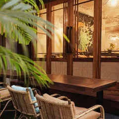 As evening falls, the cafe transforms into a cozy, intimate space. The warm lighting and view into our studio create a perfect backdrop for a quiet dinner.