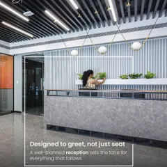 A reception desk should be designed to greet, not just to seat. This modern reception features a textured concrete-finish desk, vertical slat wall, and integrated planters, creating a sophisticated and welcoming entry point.
