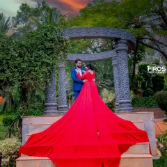 A beautiful sunset provides a dramatic backdrop for this couple's portrait. The flowing red gown adds a touch of glamour to this epic, cinematic pre-wedding photo.