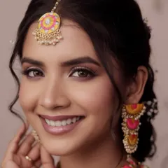 A happy, close-up smile from the 'Khushnuma' look. This shot highlights the flawless, radiant skin and the playful yet elegant makeup, perfect for a joyful Mehendi celebration.