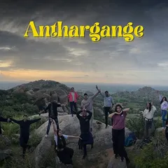 The whole crew posing at the top of Anthargange, with the unique rocky landscape stretching out behind them.