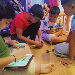 Collaboration is key. Here, students work together, combining their building and coding skills to create a functional robotic model.