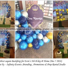 A simple and elegant silver sequin theme for a fifth birthday at home. The setup includes a "FIVE" table and a blue and silver balloon garland, adding a touch of sparkle to the celebration.