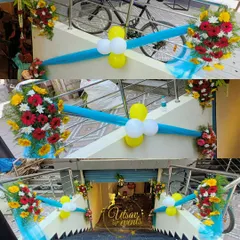 A simple and bright floral decoration for an office opening. The entrance stairway is adorned with colorful flower bouquets and balloons to welcome guests.