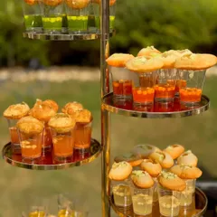 My Ambala ke Gol Gappe, elegantly presented in a three-tiered stand with various flavoured waters. It's a burst of tangy, spicy, and sweet luxury in every bite.