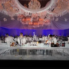 A closer look at the grand ice bar setup, showcasing the clarity of the ice and the professional arrangement of top-shelf spirits. Our team ensures the bar is not only stunning but also fully functional and well-stocked throughout the event.