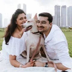 A perfect family portrait with the Mumbai skyline in the background. During this outdoor couple and pet photoshoot, we took a moment to get a classic shot of everyone looking at the camera, full of smiles.