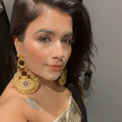 A client looking absolutely radiant in my oversized gold-tone chaandbali earrings. These statement pieces are designed to be bold and beautiful, perfect for making an impression at any celebration.