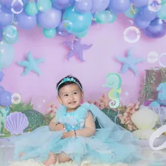Our little mermaid is one! This underwater theme with bubbles, starfish, and a beautiful mermaid dress is a whimsical way to celebrate her first birthday.