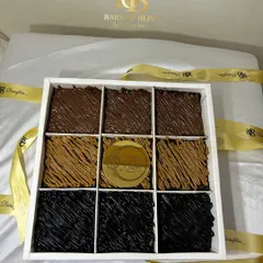 A top-down view of my nine-piece assorted brownie box for Raksha Bandhan. You can clearly see the different toppings for the Nutella, Lotus Biscoff, and Truffle brownies.