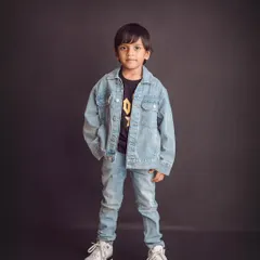 Cool and confident. A classic denim-on-denim look against a dark backdrop creates a timeless and stylish portrait for this little man.